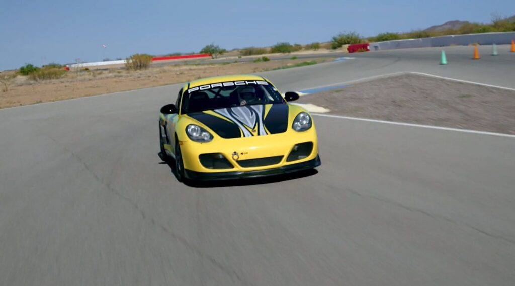 Yellow Porsche Cayman number 47 on track on Beat the Pro