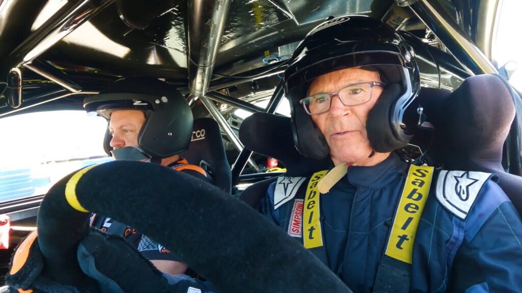 Randy Pobst at the wheel with a passenger on Beat the Pro